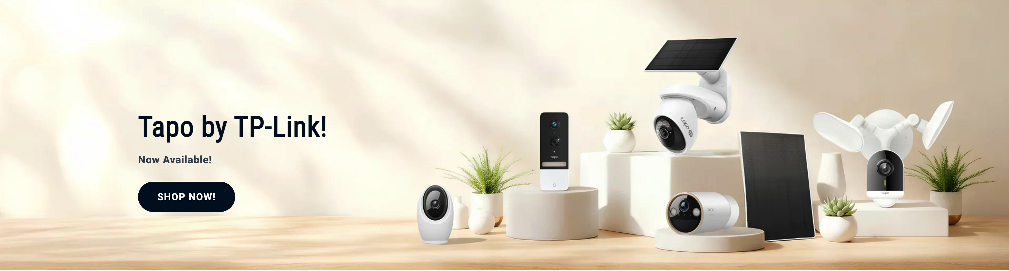 Tapo smart home cameras and solar panels on cream display plinths